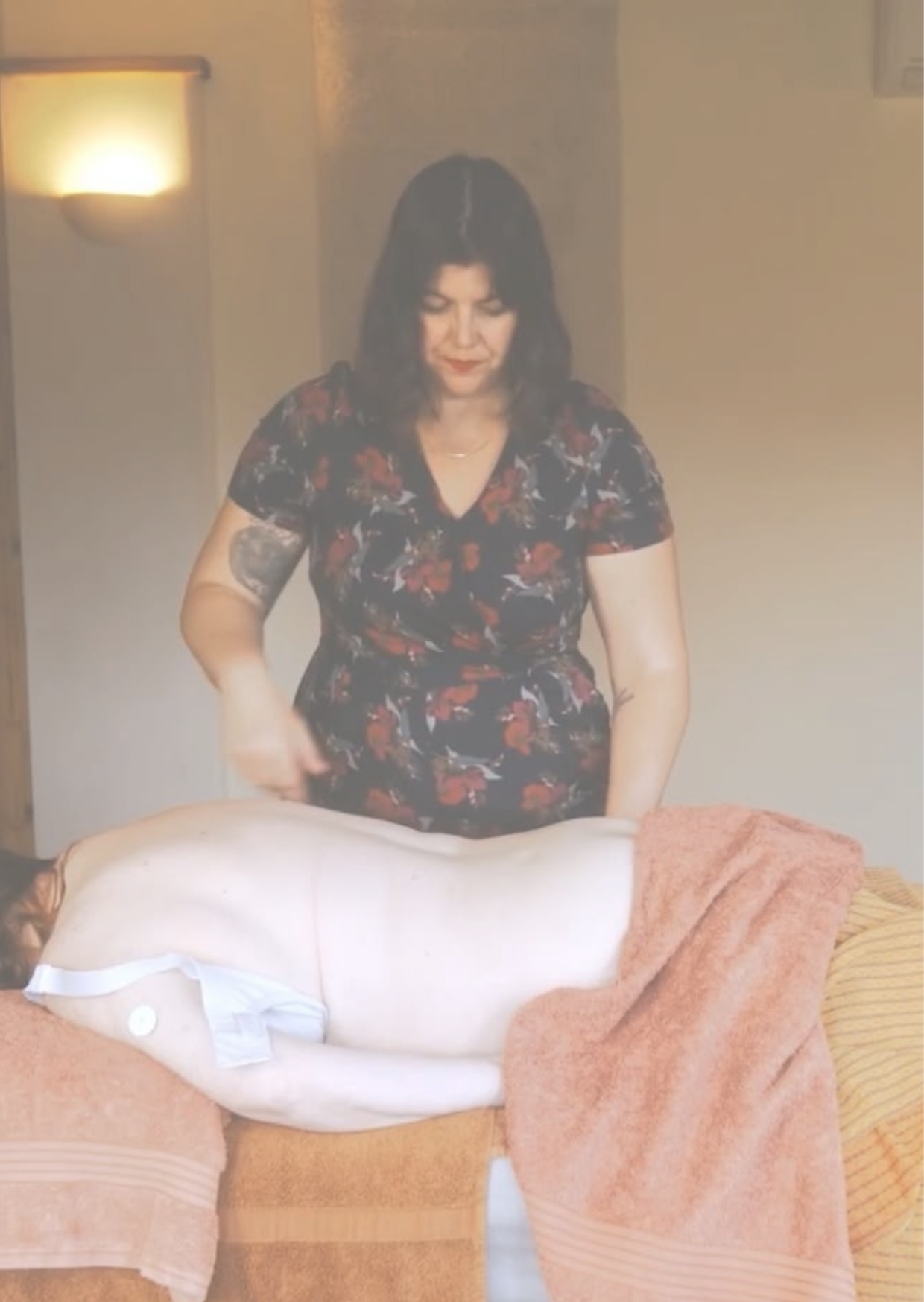 Holistic massage therapist demonstrating massage during training