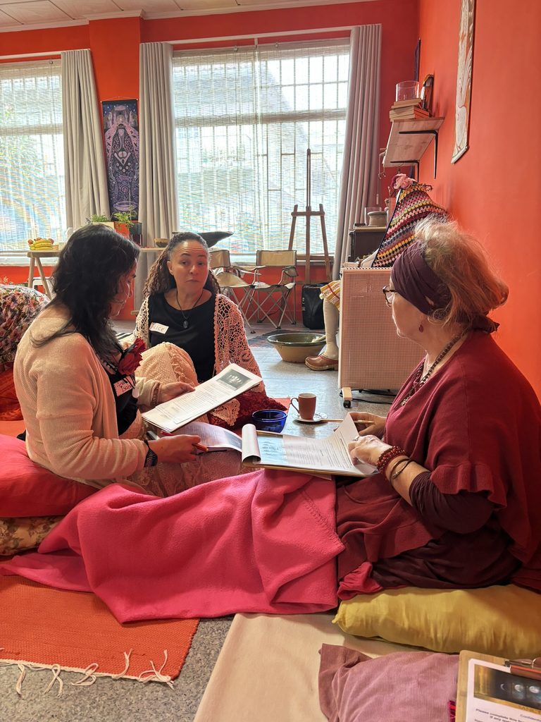Women learning together during a Sanctuary of Sophia womb healing practitioner training